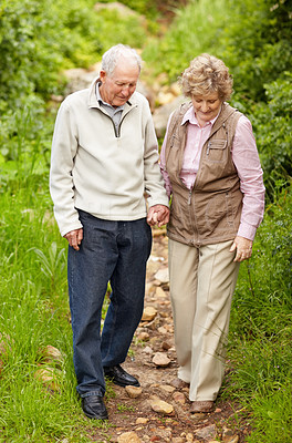 Happy mature couple walking together in countryside