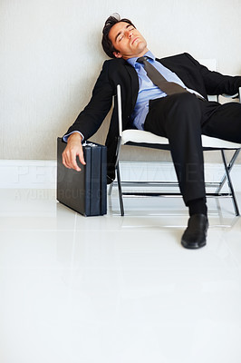 Tired business man sleeping on chair with copyspace