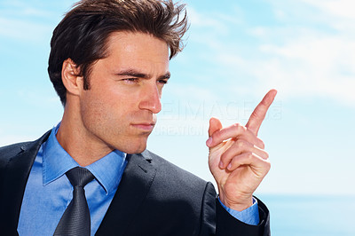 Business authoritative- Young serious man pointing his finger