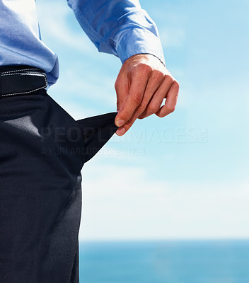 Closeup of bankrupt business man stands with turned out pocket