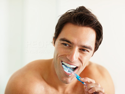 Closeup of a young man brushing his teeth