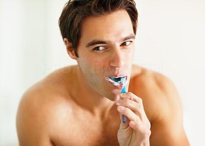 Hygiene - Handsome young guy brushing his teeth