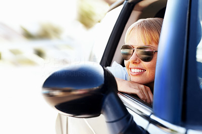 Modern smiling female enjoying a car ride