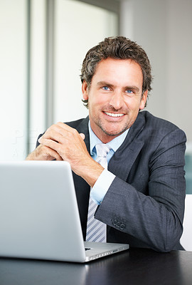 Smiling business man using laptop