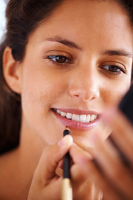 Beautiful woman applying lip liner