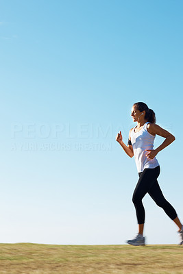 Healthy woman running on grass