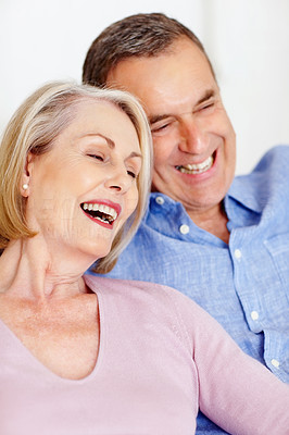 Cheerful mature couple together having fun against white