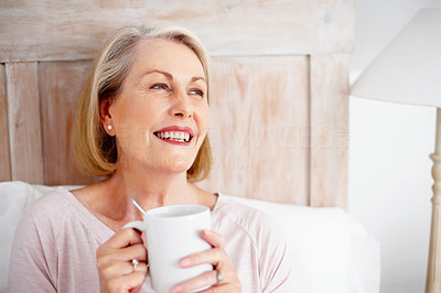 Cheerful mature woman holding coffee mug