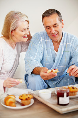 Couple having breakfast with a mature man applying jam