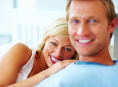 Happy middle aged woman resting on man\'s chest