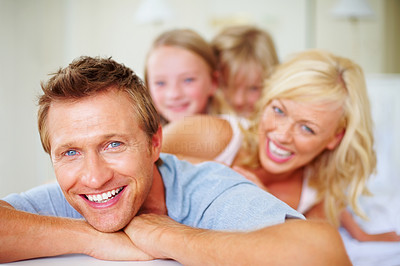 Smiling middle aged man with his family in background