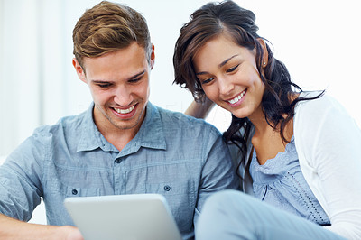 Attractive couple using tablet PC at home