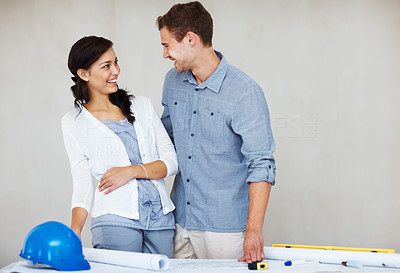 Cheerful young couple discussing house plan