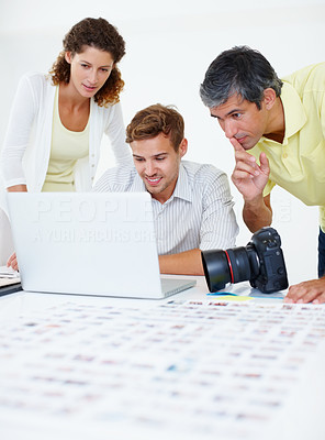 Professional photographers using laptop