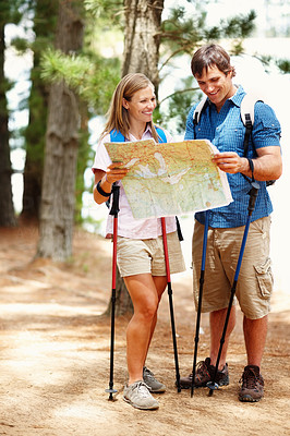 Couple taking a break from hiking and looking at map