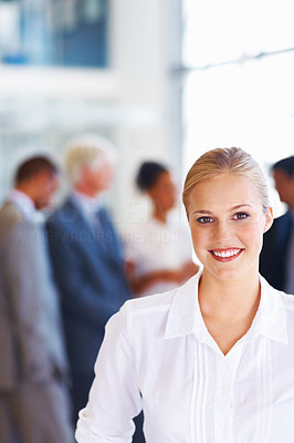 Female executive smiling with business group
