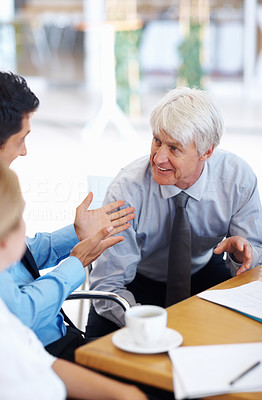 Male executives with business woman in conversation