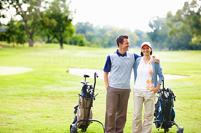 Couple standing on golf course
