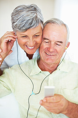 Mature couple listening music at home