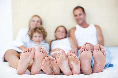 Family feet in bed