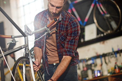 Tinkering away with his bicycles