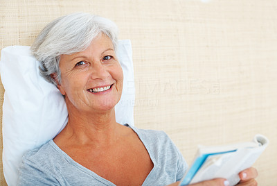 Smiling senior woman reading book