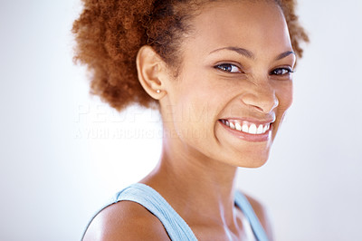 Beautiful young female smiling against grey background