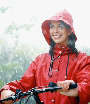 Woman in raincoat going for bike ride