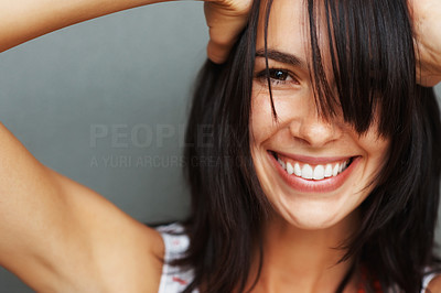 Casual woman smiling with hands on head