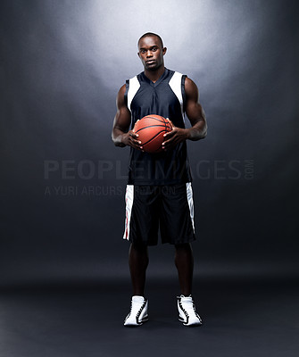 Young male basketball player with basketball