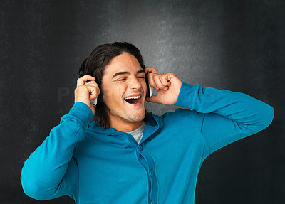 Man listening to headphones and singing