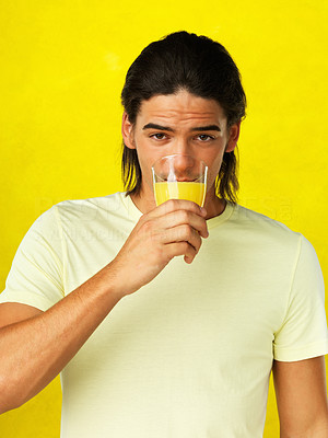 Handsome man drinking orange juice