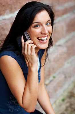 Pretty young girl enjoying conversation on mobile phone