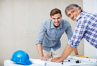Contractor reviewing blueprint with client