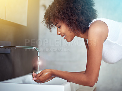 Washing her face to complete the wake up