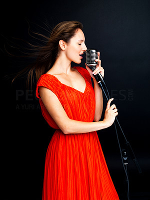 Rock star - Pretty woman singing in retro mic