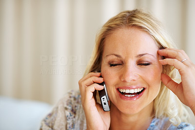 Happy young female talking on mobile phone