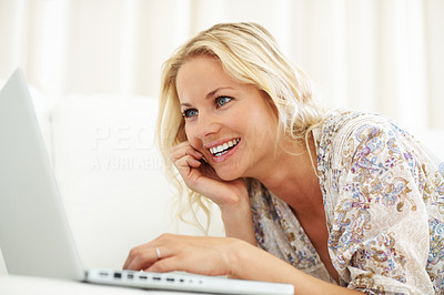 Pretty happy young woman using a laptop
