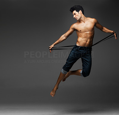 Flying muscular sexy man against gray background