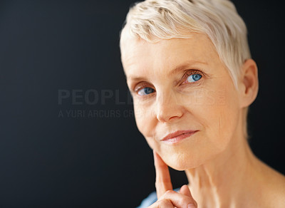 Beautiful blue eyed senior lady looking away from copyspace