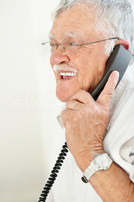 Closeup of relaxed aged man using telephone