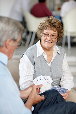 Enjoying retirement - Senior couple playing cards
