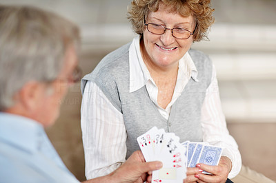 Enjoying retirement - Old couple playing cards