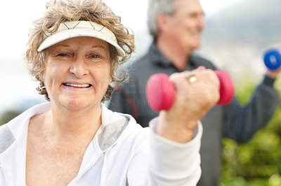 Senior woman doing exercise with a dumbell