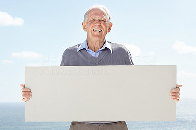 Handsome old man holding blank billboard - Outdoor