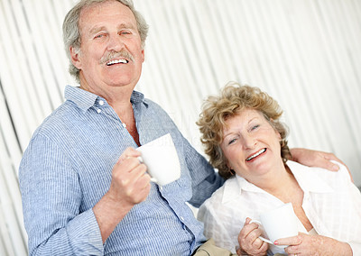 Happy mature couple enjoying coffee together