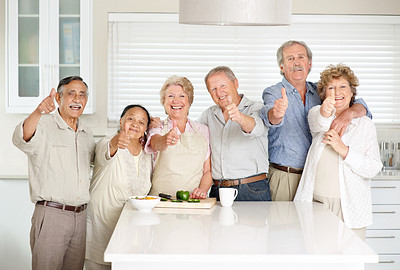 Smiling old couples showing thumbs up sign