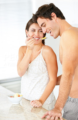 Happy young couple enjoying meal in the kitchen
