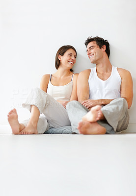 Lovely young couple relaxing on the floor