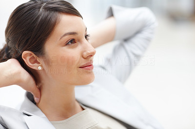Relaxed young woman lost in deep thought